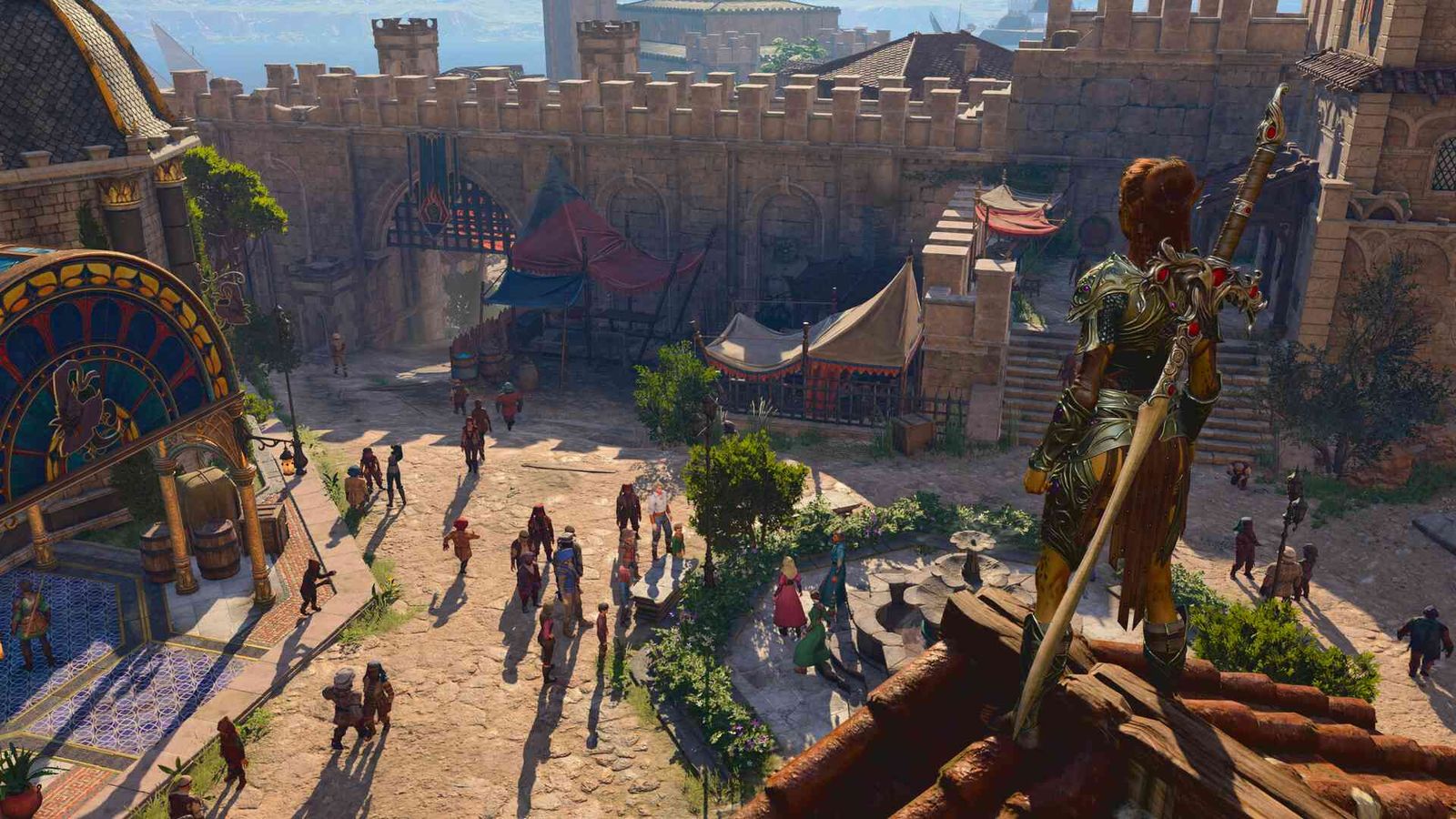 The player character looking across a town courtyard in Baldur's Gate 3.