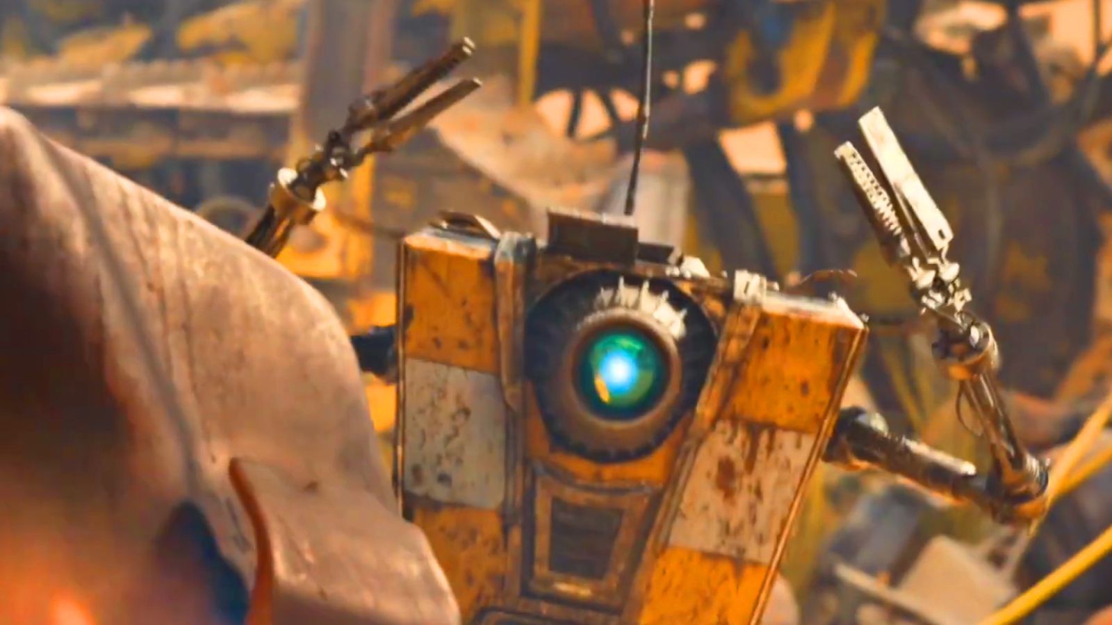 A screenshot of the Borderlands movie showing Claptrap surrendering behind a mailbox 