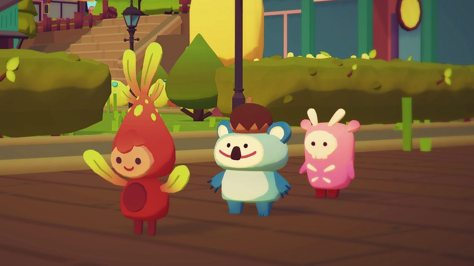 Three ooblets stood in a line on a pathway, with trees in the background