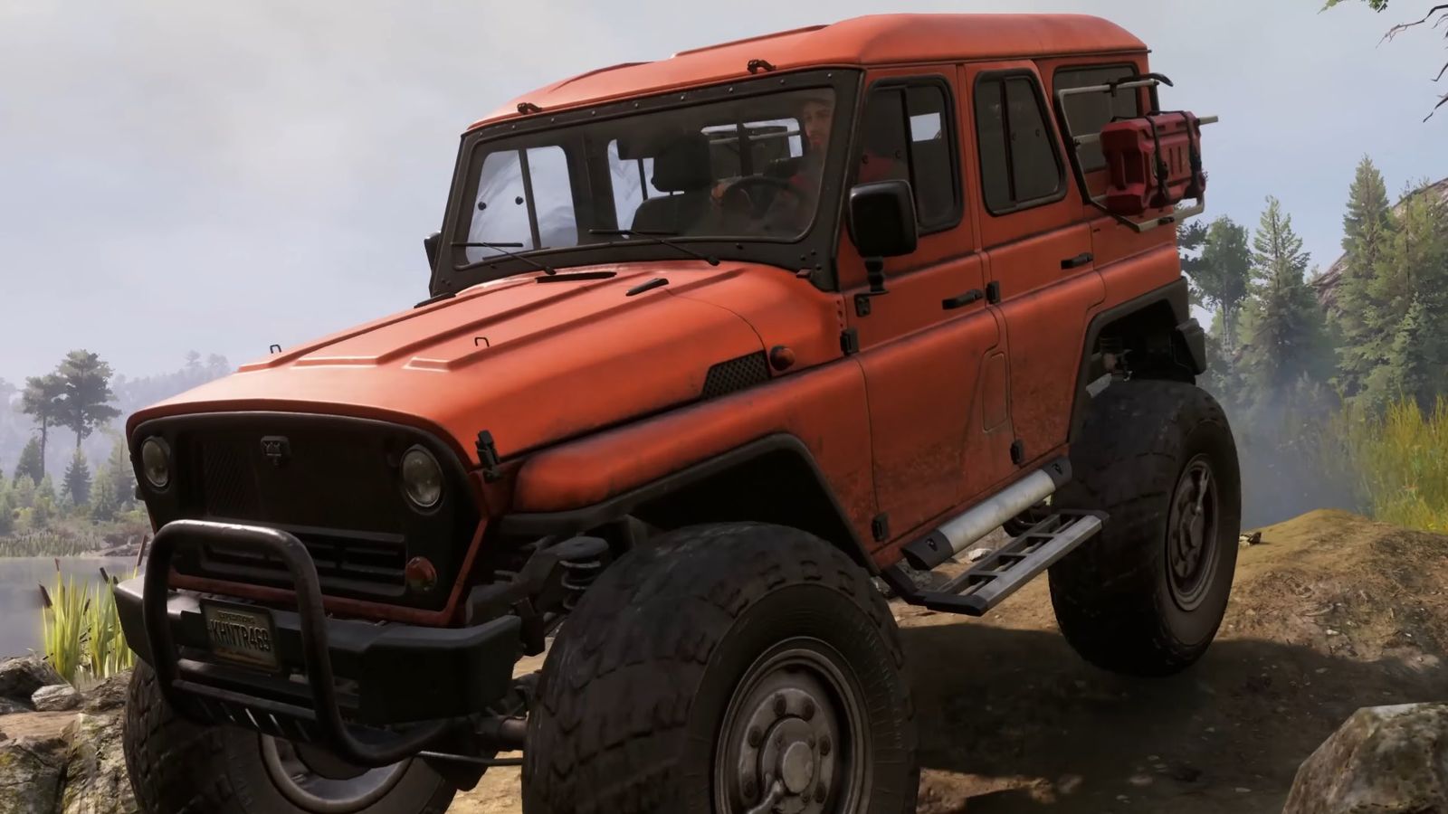 An orange 4x4 Jeep posing on top of a cliff 