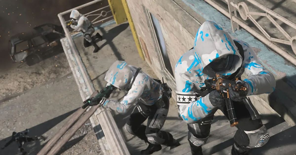 Screenshot of Warzone 2 playhers moving up staircase on the side of a building. All 3 players are holding a submachine gun and wearing a blue and white ranked play hoodie