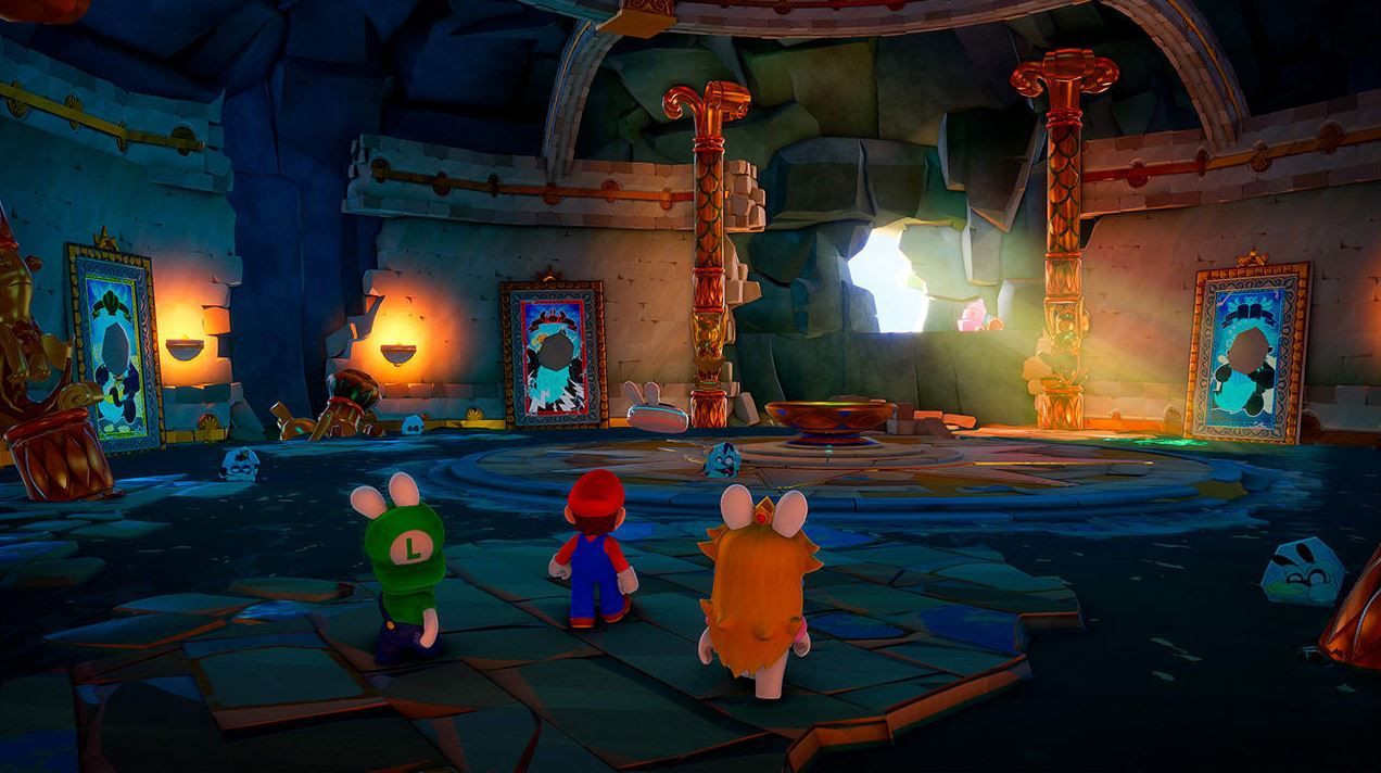 This image shows Rabbid Luigi, Rabbid Peach and Mario standing in a large hall. 