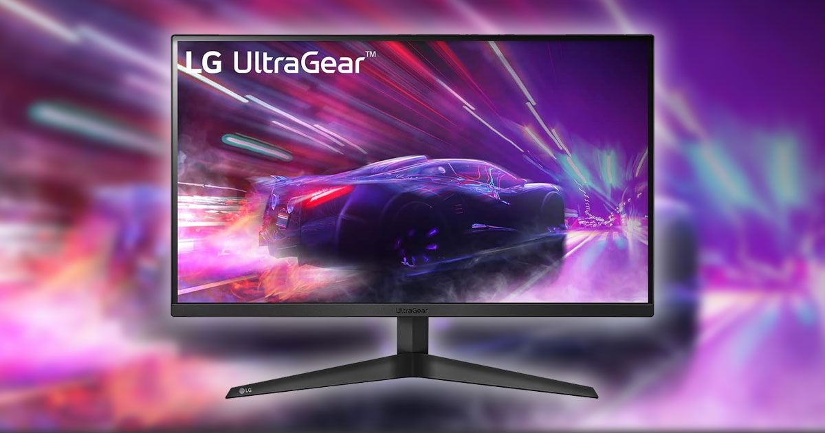 A black LG monitor with a purple car racing through pink streaking lights on the display, with the same image blurry in the background.