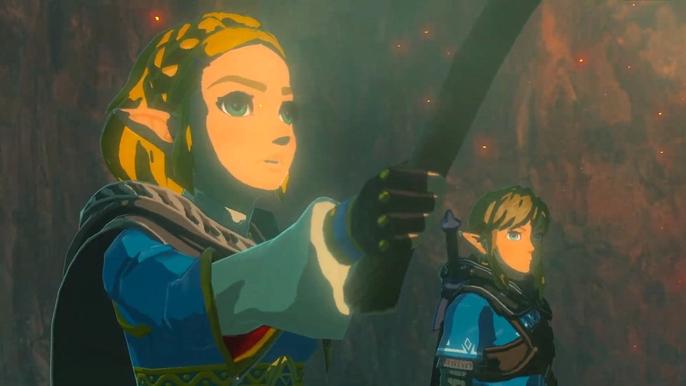 A screenshot of Princess Zelda and Link from the Breath of the Wild. Zelda is in the foreground with her hand out holding something, while Link is in the background. They are both dressed in blue, stood in a red, misty cave setting.