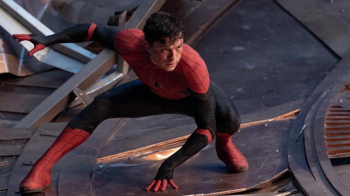 Tom Holland is perched on a slivery, metal floor.