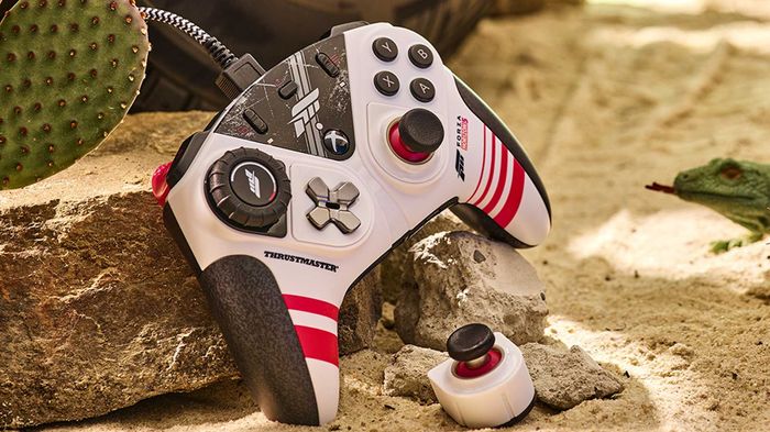 The Thrustmaster ESWAP XR Pro Controller Forza Horizon 5 edition against a sandy background.