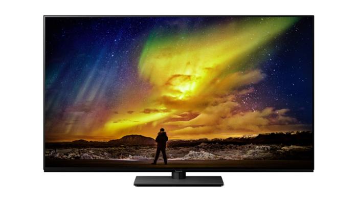 Best OLED TV - Panasonic TX-55LZ980B product image of a black-framed TV with a man looking at the Northern Lights on the display.