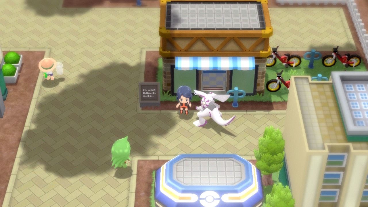 A Pokémon Trainer and their Palkia standing outside the Cycle Shop of Eterna City in Pokémon Brilliant Diamond and Shining Pearl.
