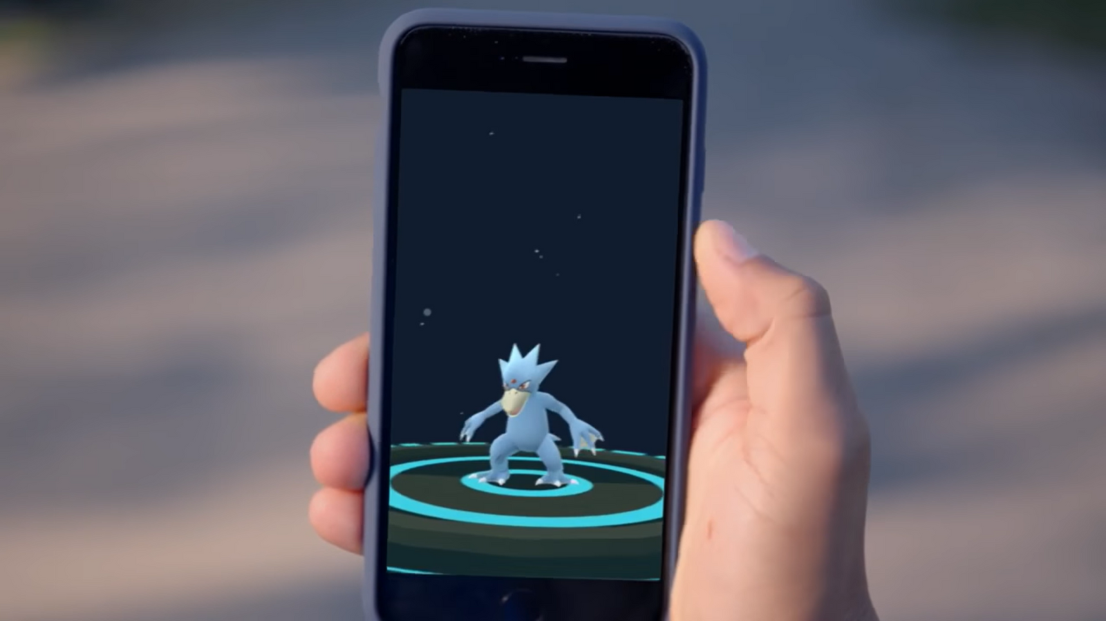 Player holding a phone showing their Golduck in Pokemon GO.