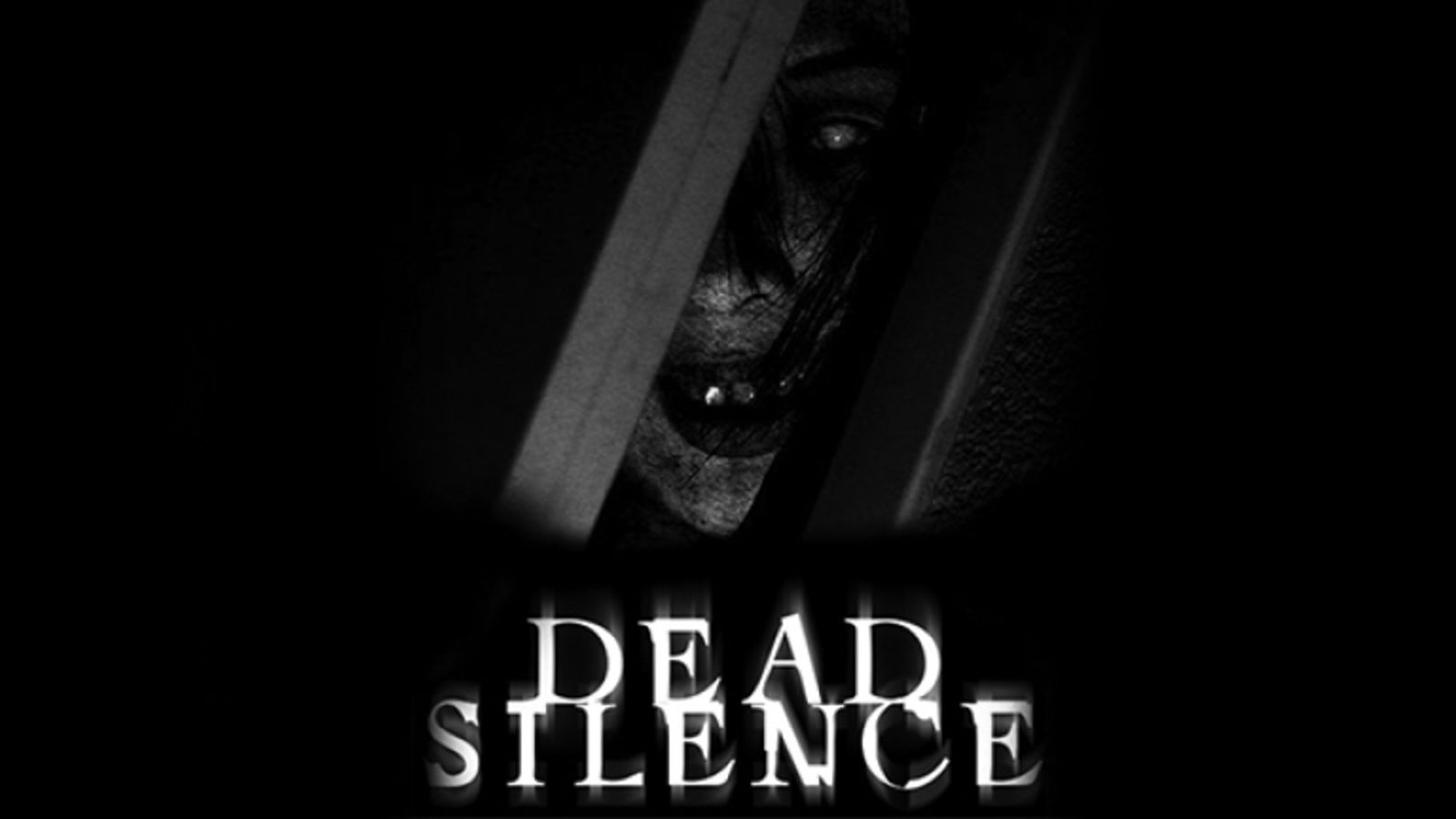 Screenshot from Dead Silence, showing a demonic face locked behind bars