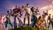 Image of a group of Fortnite characters standing on a hill top, including Optimus Prime and a character wearing a light brown shirt and khaki trousers in the centre.