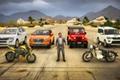 A character stood next to various vehicles in Indian Bikes Driving 3D.