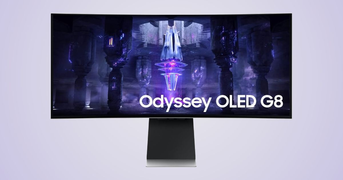 An ultrawide grey monitor with a near-frameless design and an image of a purple crystal on the display.