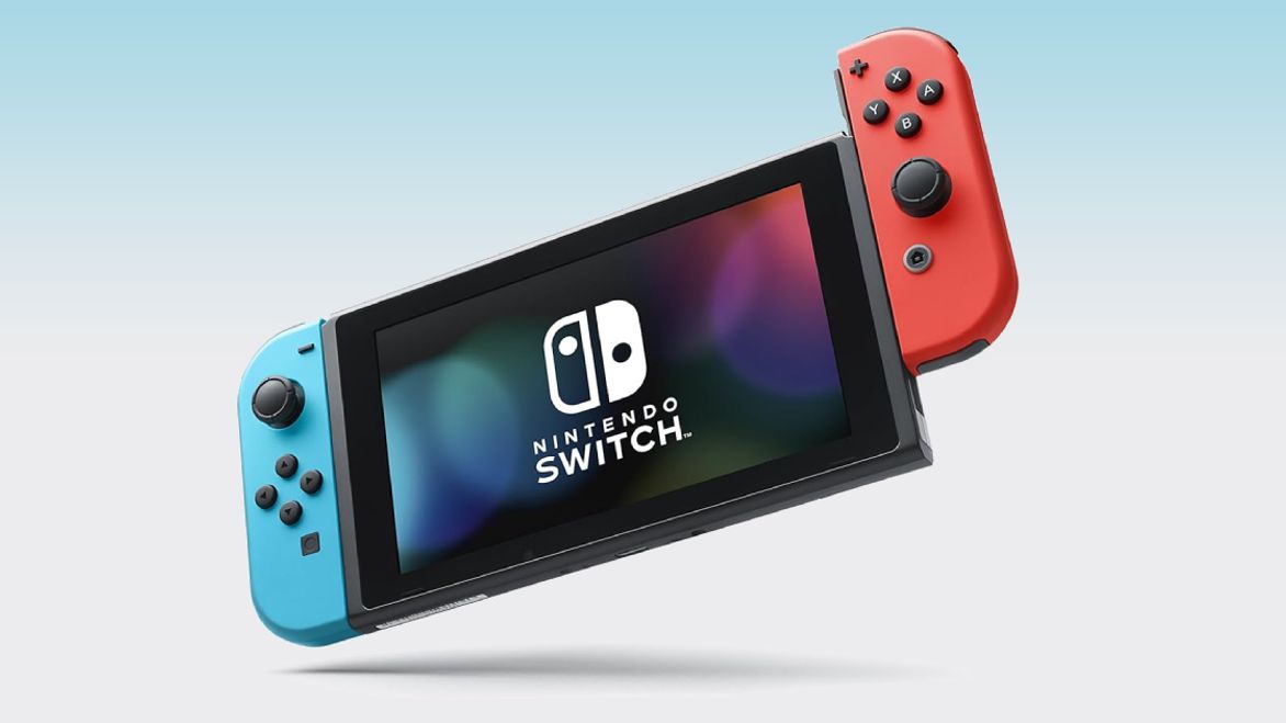 The black Nintendo Switch OLED with a blue controller connected on the left, and a red one on the right.