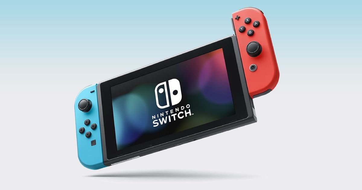 The black Nintendo Switch OLED with a blue controller connected on the left, and a red one on the right.