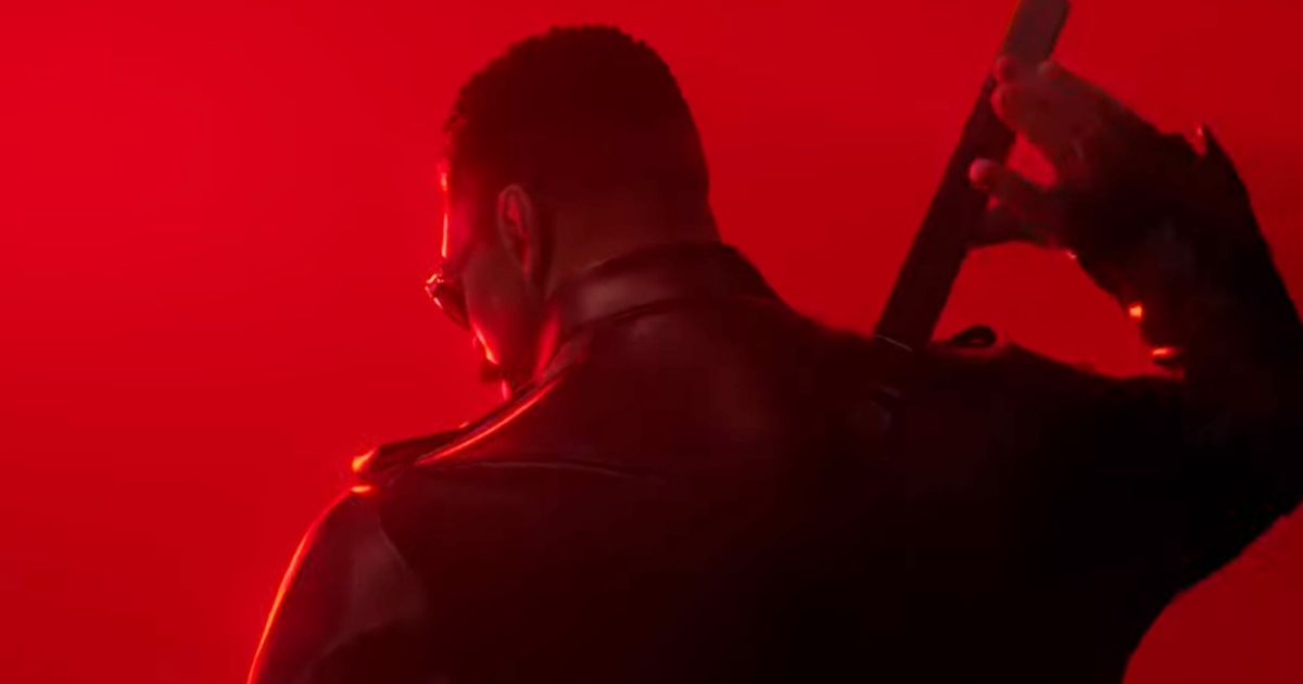 Blade the Vampire Hunter standing in a red background holding his sword hilt 