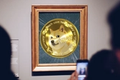 Dogecoin artwork in a frame at a gallery, representing the creation of a DOGE NFT.