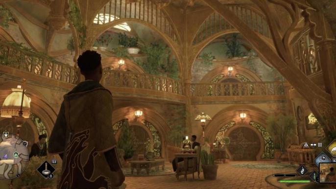 A student walking through a brightly lit hall in Hogwarts Legacy.
