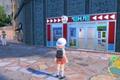 A trainer stood outside a store in Pokemon Scarlet and Violet.