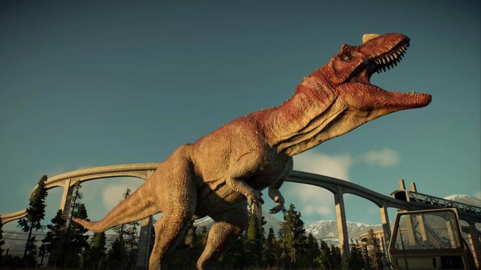 Jurassic World Evolution 2. A Ceratosaurus dinosaur can be seen roaring into the sky. The monorail transport track can be seen in the background. 