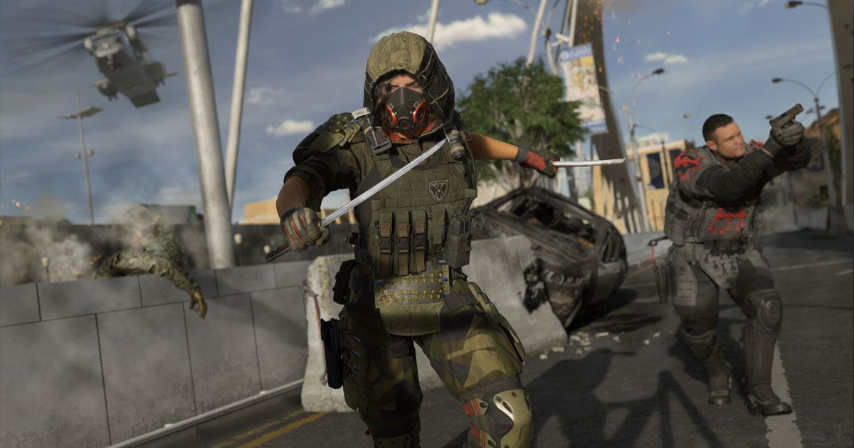 A character in Warzone wearing green armour while holding a knife.