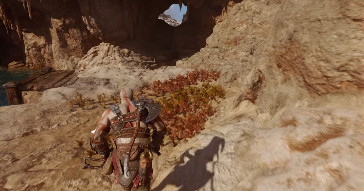 Kratos running through a cave in God of War Ragnarok 
