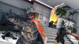 Modern Warfare 3 players guarding staircase while holding guns. An explosion is in the background