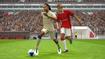 Screenshot from eFootball PES 2021, showing Ronaldinho and David Beckham competing for the ball