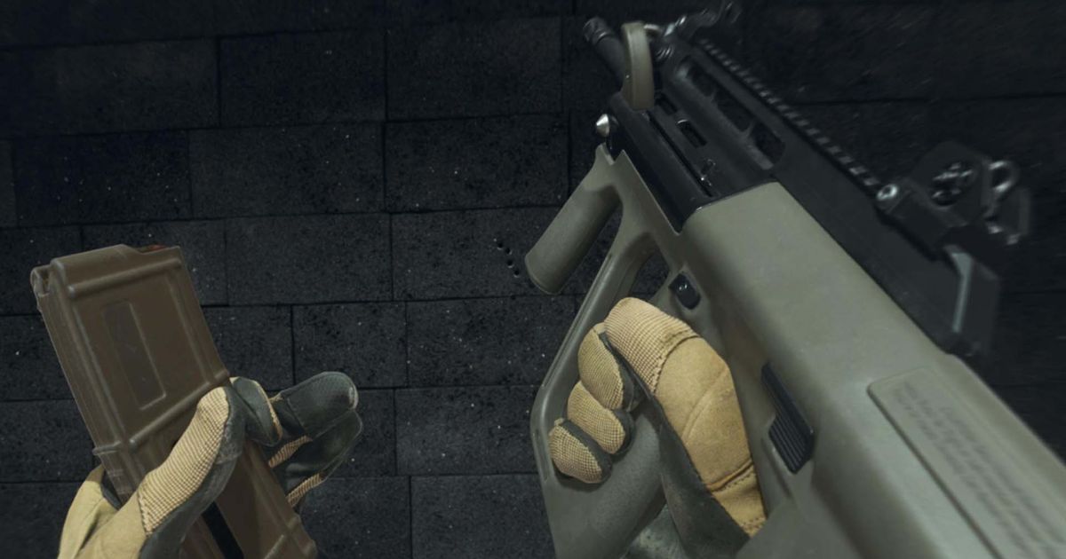 Modern Warfare 3 STB 556 assault rifle in hands of player wearing pale yellow and black gloves