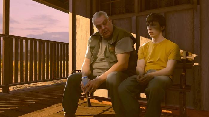 Image of a father and son sat together in As Dusk Falls.