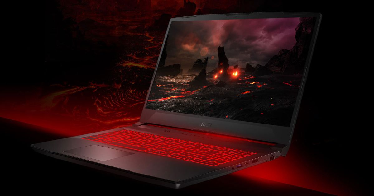 A black gaming laptop with a dark fiery scene on the display and red backlit keys.