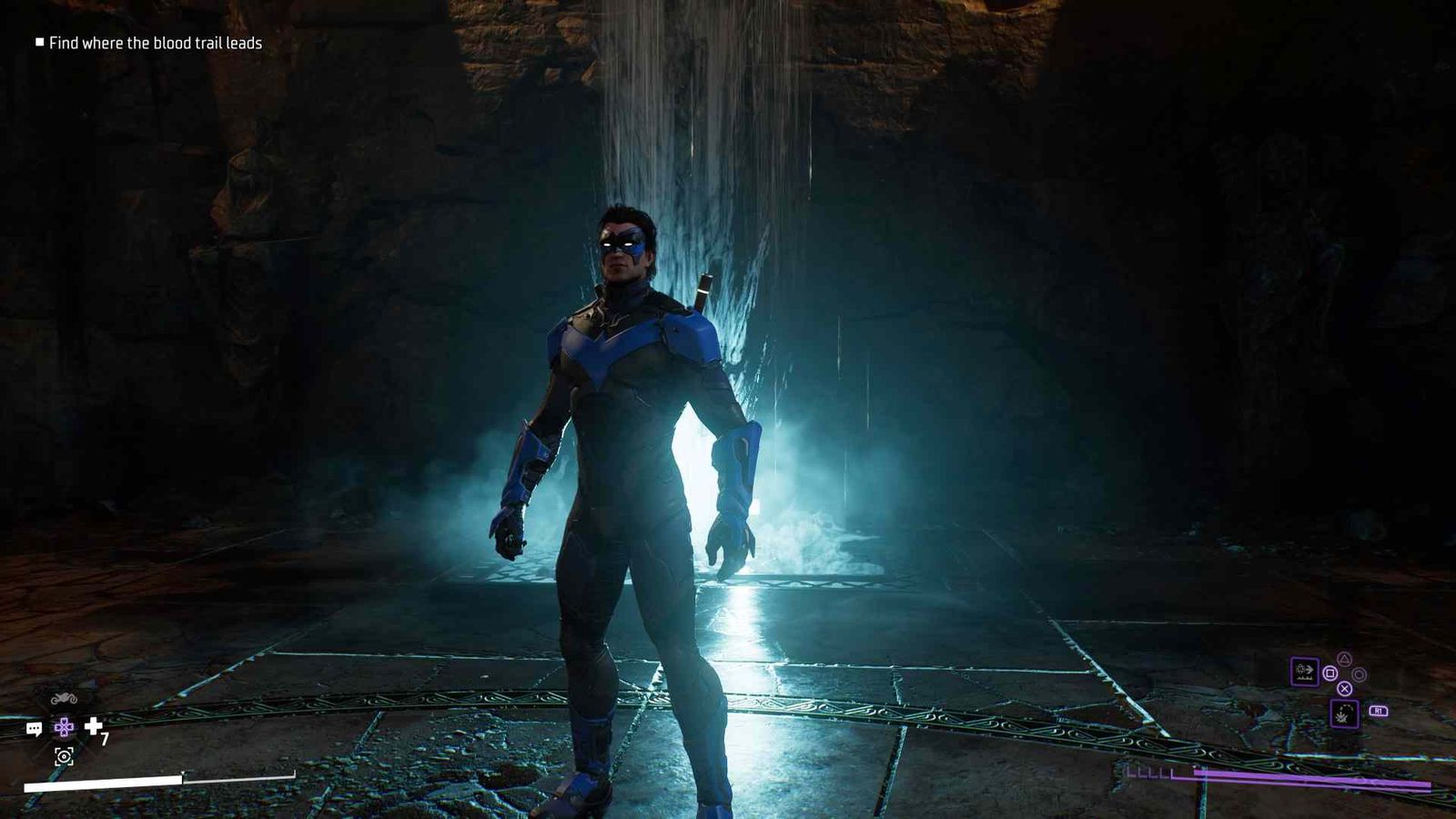 Nightwing standing in an illuminated cave in Gotham Knights.