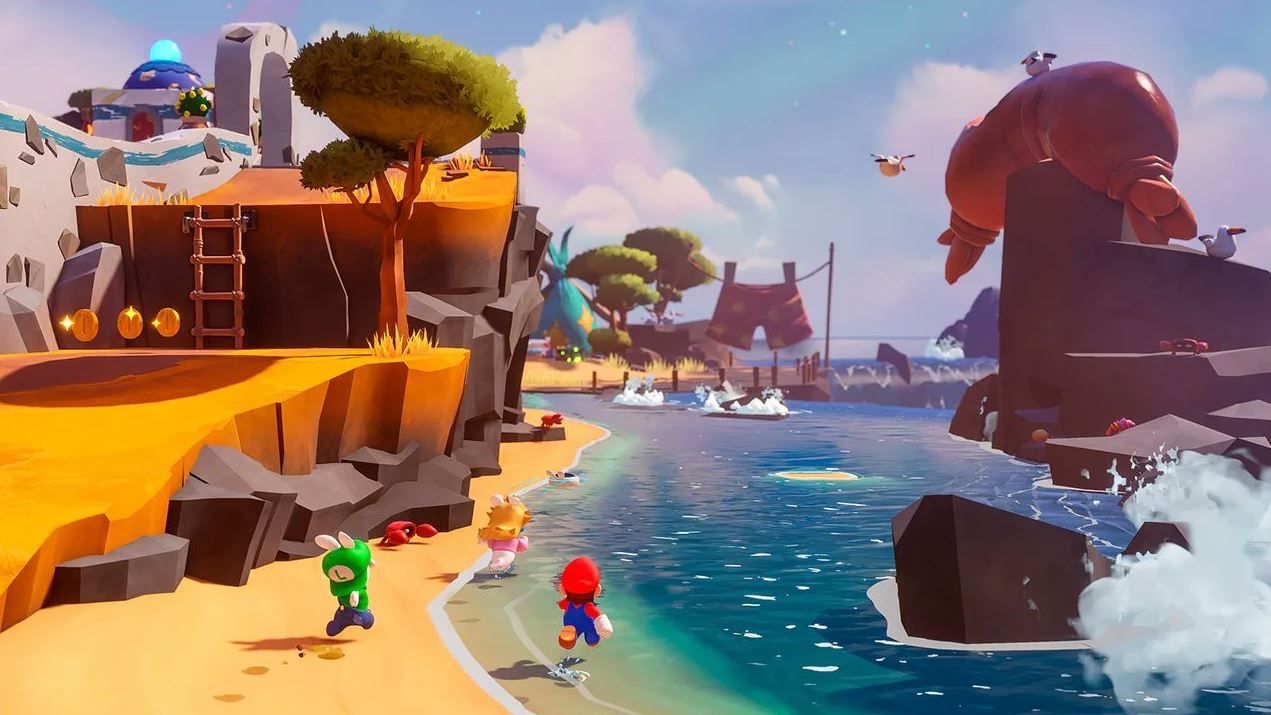 The image shows Mario, Rabbid Peach and Rabid Luigi running along a beach. 