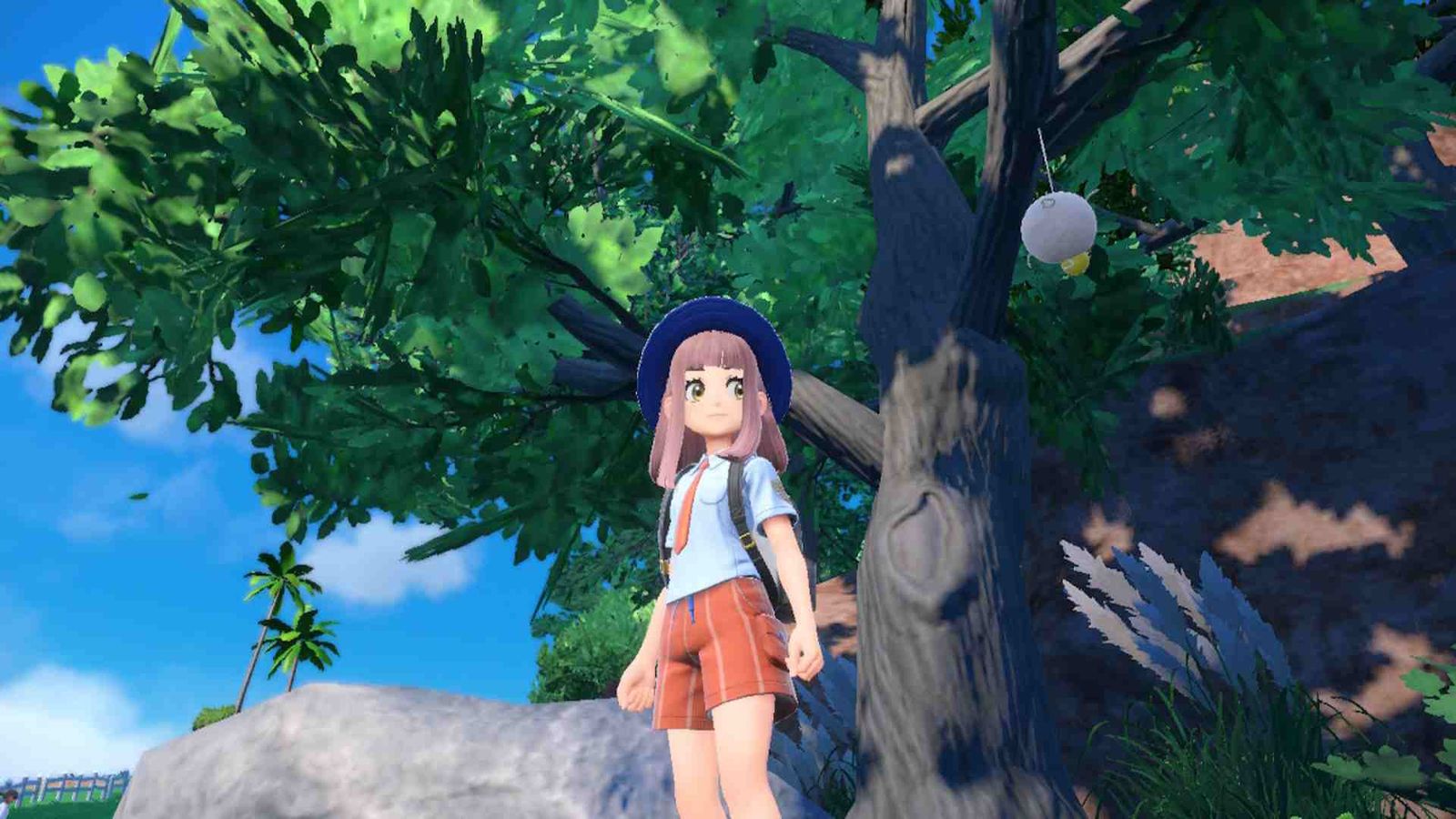 A Pokemon trainer looking in the wild areas in Pokemon Scarlet and Violet.