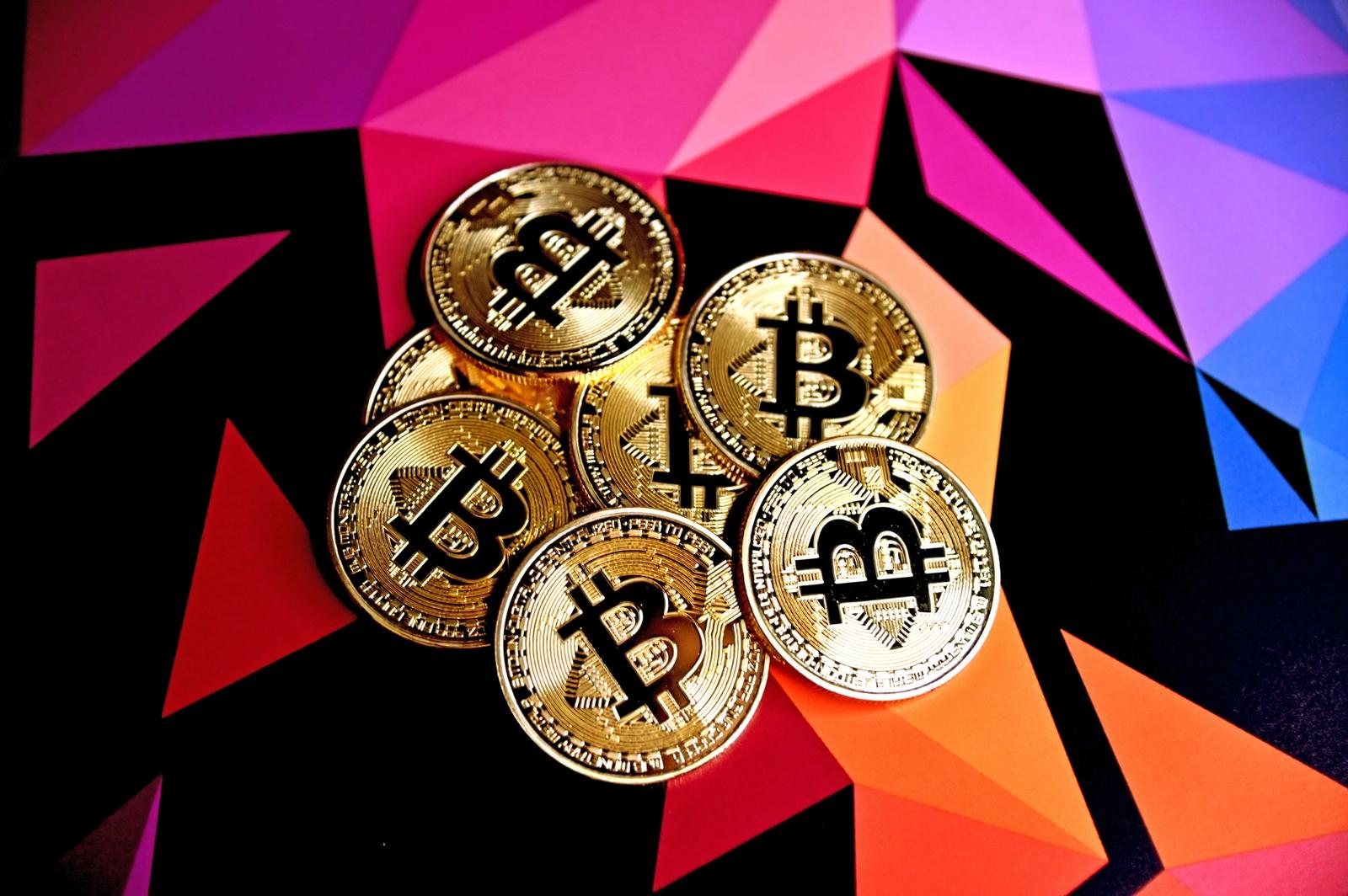 Bitcoin tokens on a colorful background