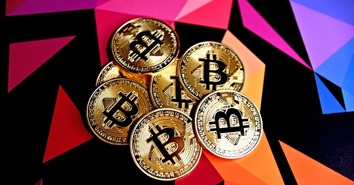 Bitcoin tokens on a colorful background