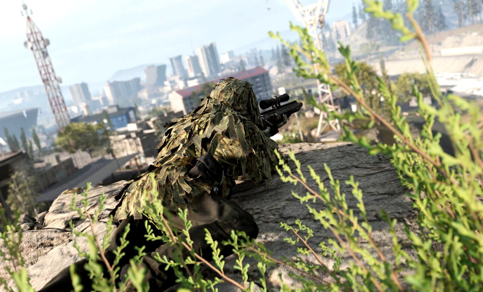 Modern Warfare 3 player laying prone with sniper rifle while wearing ghillie suit