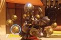 Overwatch 2 - Zenyatta with orbs hovering in a ring around him, with his left palm raised to the camera
