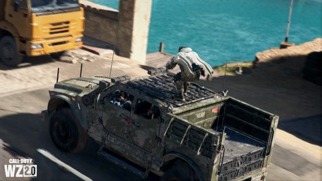 Image showing Warzone 2 player standing on top of moving SUV