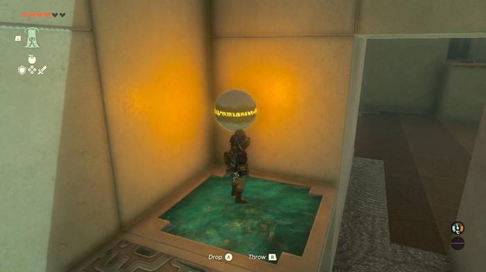 Link holding a metal ball in the Orochium shrine.