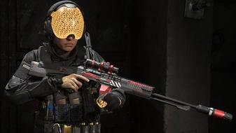Modern Warfare 3 player holding marksman rifle while wearing gold visor