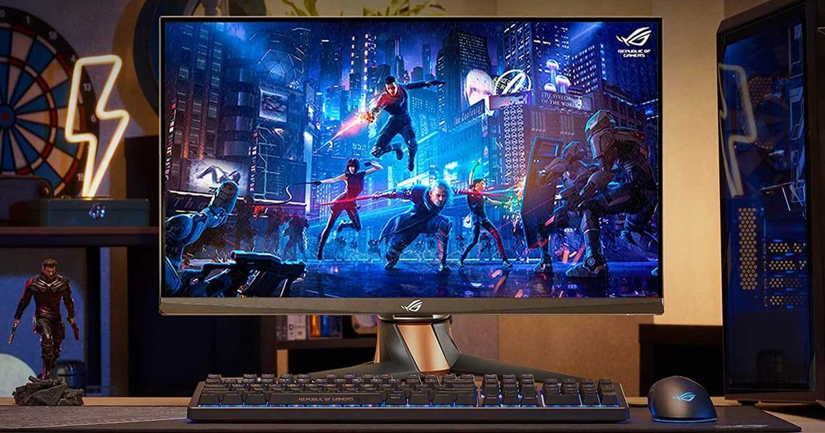 A monitor sat behind a keyboard with a group of four heros fighting off enemies in a dark city on the display.