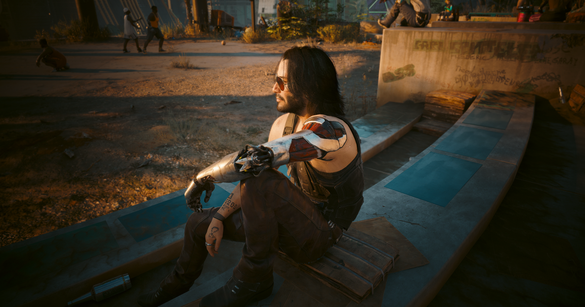 A man with a silver left arm and red sunglasses sits on a bench, looking into the distance, in Cyberpunk 2077 Phantom Liberty