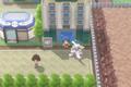 A Pokémon Trainer and their Palkia standing outside of the Eterna Condominiums of Eterna City in Pokémon Brilliant Diamond and Shining Pearl.