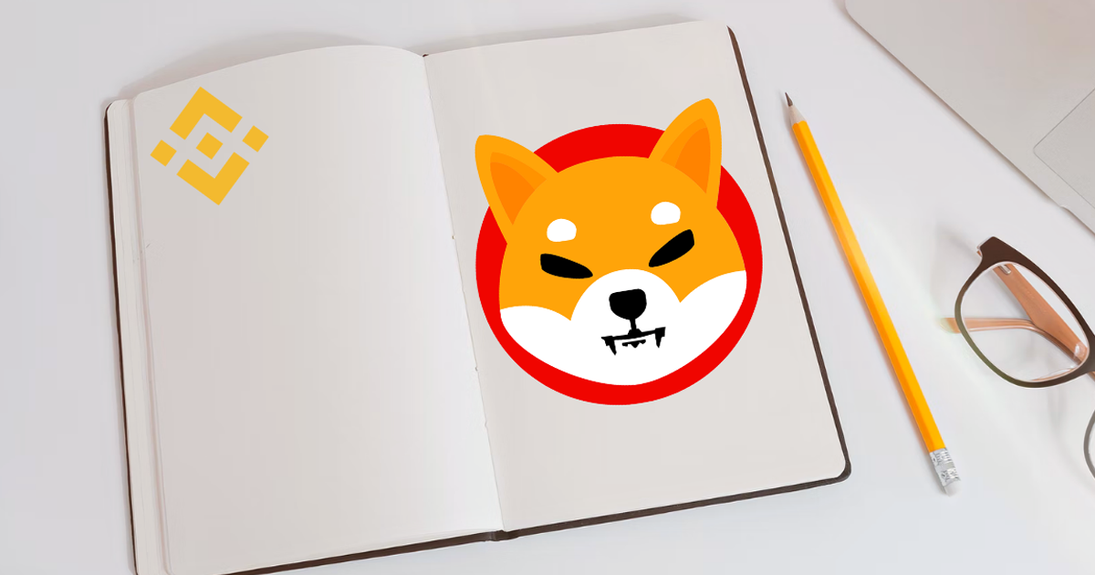 Shiba Inu (SHIB) logo on a page in a notebook, next to a pencil and glasses. On the left page, is a Binance logo