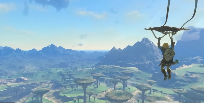 Link gliding with his paraglider over the ground below. 