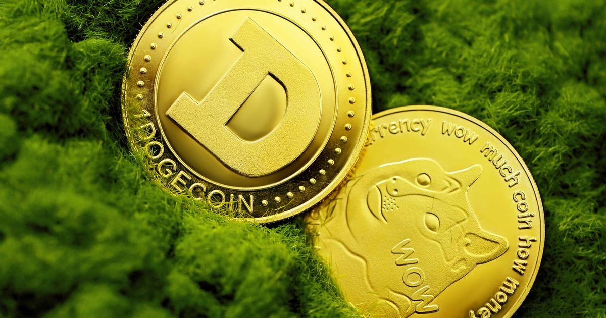 Two Dogecoin Coins in green fabric.