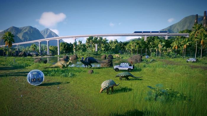 Jurassic World Evolution 2 Gyrosphere inside herbivore enclosure. There is a ranger team in the middle of the image and a handful of herbivorous dinosaurs.