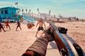 Dead Island 2 player holding gun on beach in front of zombies