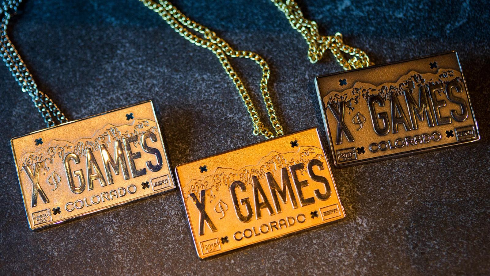 It's three necklaces earned from being in the X Games in Colorado. They're golden squares